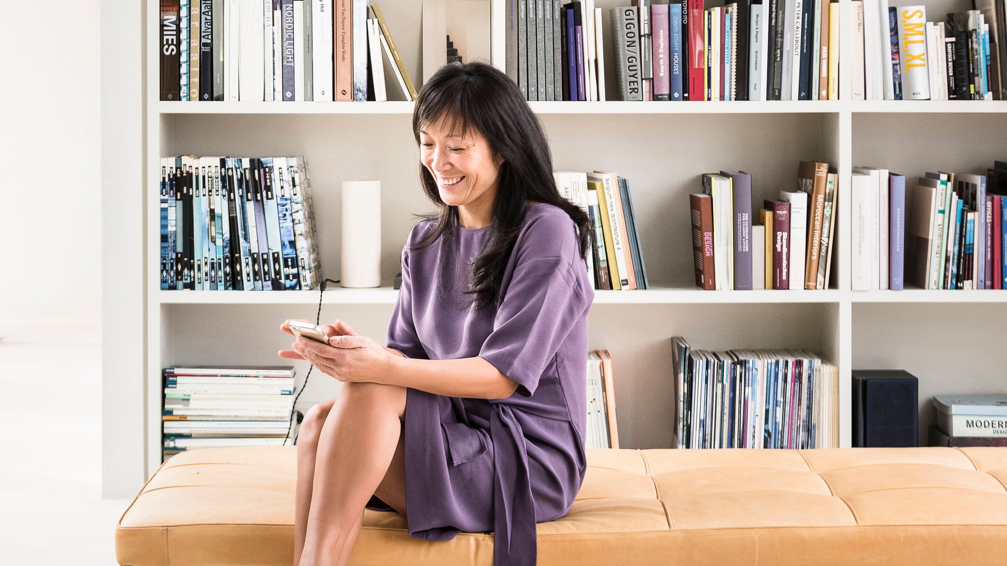 Egy nő használja az Onecta alkalmazást az otthona fűtése, hűtése és használati meleg vize szabályozására