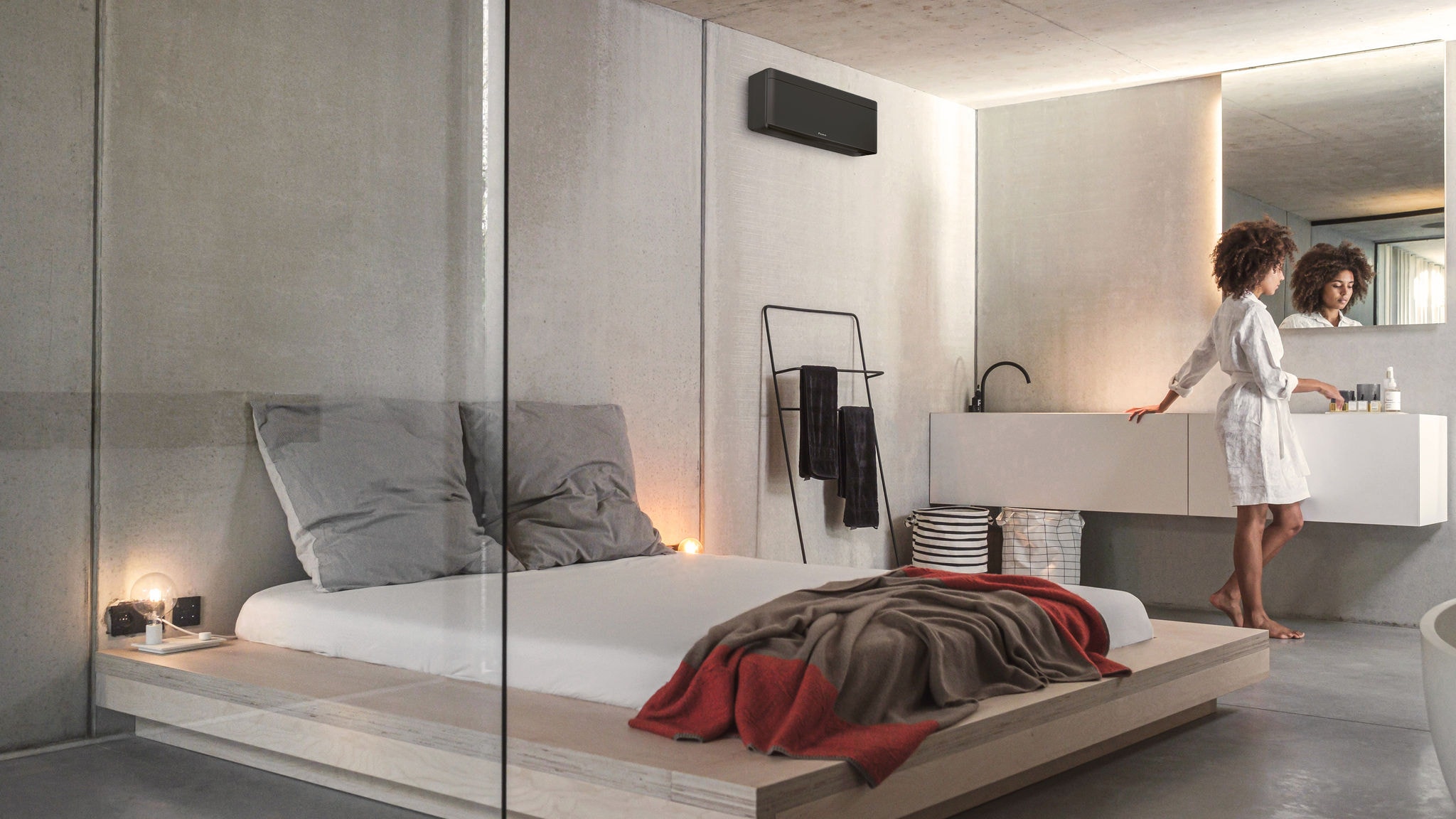 Egy nő készülődik a hálószobában és a fürdőben, ahol a Stylish beltéri egység kondicionálja és fűti fel a levegőt